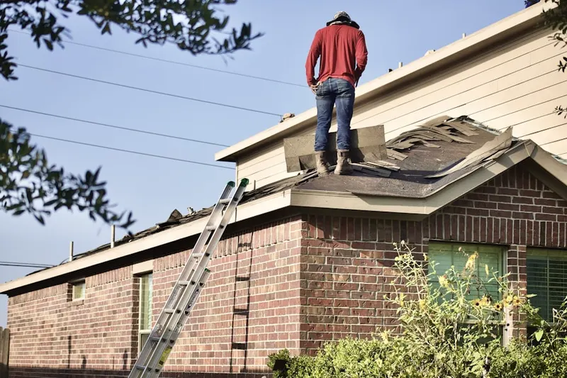 Professional roofer working on a residential roof in Sanford Farms